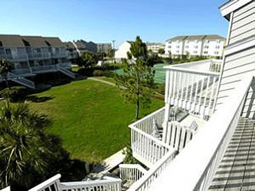 View from Master Balcony of the fabulous open courtyard.  Tennis courts to the right as well as one of two pools in Barrier Dunes.