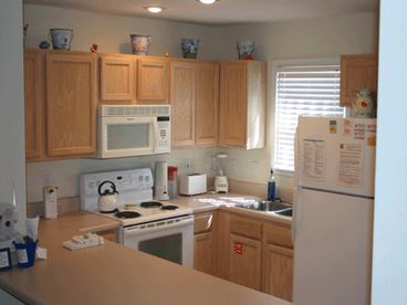 Bright and fully stocked Kitchen with laundry closet are convenient and easy to use.