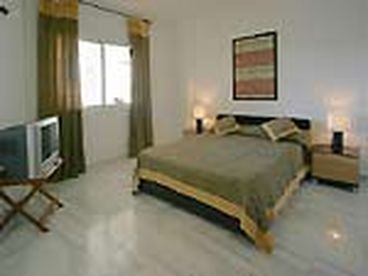 master bedroom with TV and ensutie bathroom