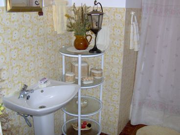 The tree enchantment bathroom with flower and tree tiles and also a full bathroom with full linens