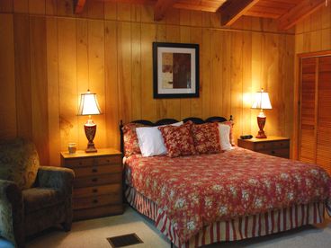 Master bedroom with king-sized bed and attached bath