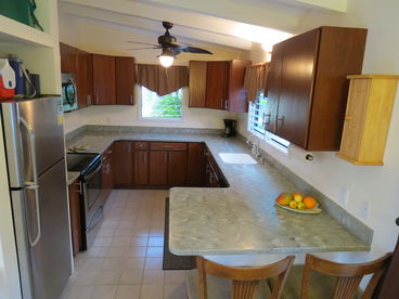 Full kitchen with solid surface countertops, real oak cabinets and stainless steel appliances