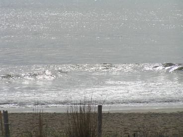 The relaxing sight of the beach and waves off the sundeck.  The beach is steps away.