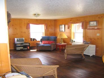 The living room has comfortable chairs and sofa for reading and watching cable TV or listening to music. The futon opens out for overnight guests. A large front entry is a suitable play space for small children with books and games.