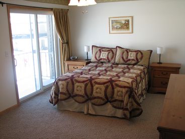 Master Bedroom with Queen bed, balcony overlooking Schroon Lake, adjoining full bath.
