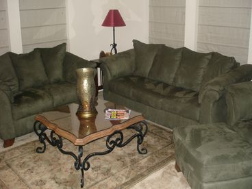 This is the spacious living room with plenty of room for your family. The gas firelace is double sided to the dining room.