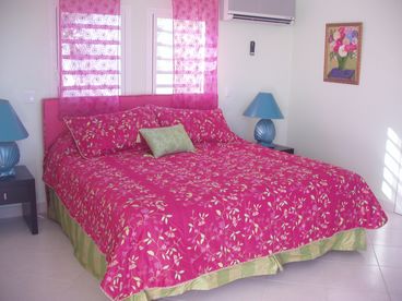 Each of the 5 bedrooms is painted in a bright tropical color