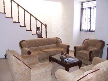 Livingroom with stairs leading to 3 bedroms