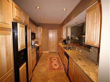 Kitchen - Gourmet kitchen with granite counter-tops and TV. Laundry Room with washer/dryer is just thru the door. 