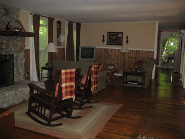 Large living area with three separate sitting areas (mission style futon/couch area not visible in photo).