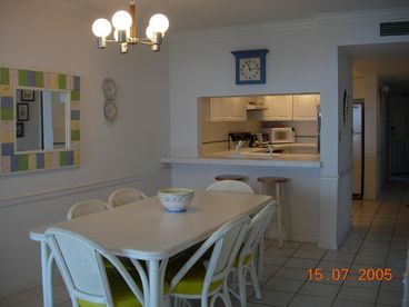 Dining table seats 8.  There is a breakfast bar behind it with two stools.