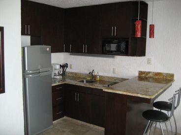 Newly renovated kitchen with granite countertops and stainless steel appliances