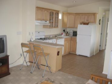 View of kitchen from living room - peak at bedroom in the backround