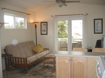 View of living room from kitchen - note the outside bistro set and also on the patio is a bbq