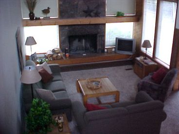 living room with fireplace - wood is furnished