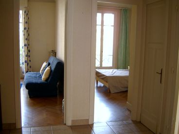 View from hall shows sitting room on left with  front bedroom on right