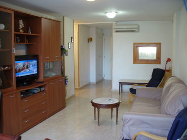 View looking at living area. entry way at back, Satellite TV, DVD player. Sofa slepps two persons. Air conditioned..