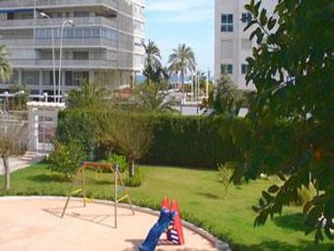 Wide view over gardens and equipped play area for children.