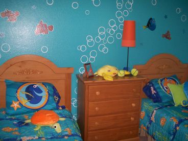 Finding Nemo bedroom with two twin beds, a large closet, and cable TV