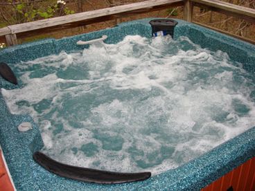 Enjoy mountain views and starry skies from the powerful 5 person hot tub with lounger