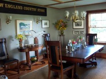 Formal Dining room seats up to 10--double south windows on porch wall look accross the meadow w cove views