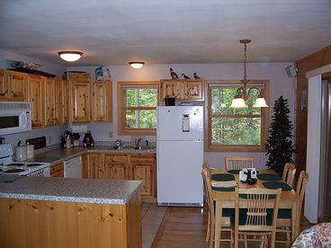 Full kitchen with dishwasher and dining area