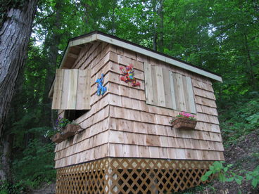 This great playhouse (new 2010) has large windows on three sides and its own porch on the fourth.  Doubles as additional sleeping quarters.