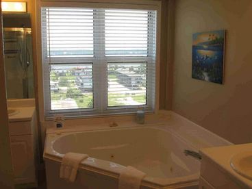 Master bath has large garden tub with view of bay.