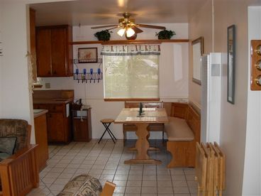 Dining table for 4 next to nice kitchen with corian counter tops, with everything you need to cook and enjoy.