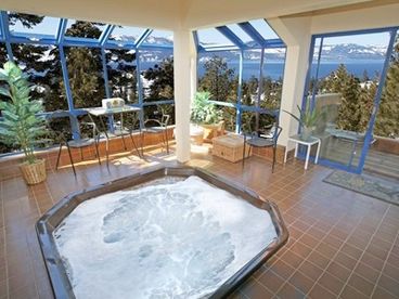 sunken hot tub in the glass enclosed solarium 