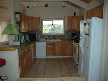 Spacious kitchen with dishwasher, stove, convection oven, rice cooker, side by side refrigerator, full pantry to right of refrigerator, all the pots/pans/utelsils you could imagine!