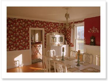 Expansive dining room with 1920s kitchen table and hutch. 