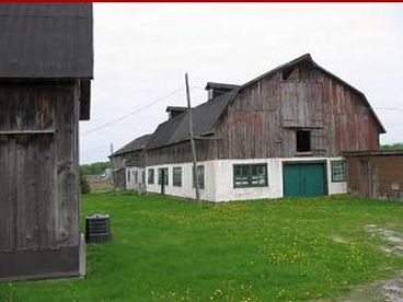 The farm has a complete set of farm buildings including cattle barn, granary, milk shed converted to a sugar shack, tractor shed, chicken coop occupied by swallows and a horse barn that is now mostly a work shop