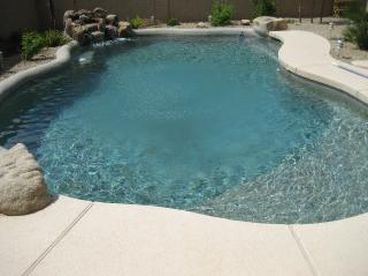 Sparkling Pebble Tec Pool! Beautiful rock waterfall feature fills the backyard with the sounds of rushing water. 