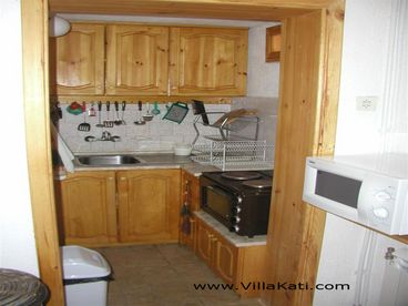 The kitchen nook extends into an additional cooking / dining area