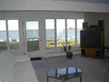 Living room overlooking islands, light house and shoreline of 5 towns.  Large screen TV with cable is a wonderful attraction!