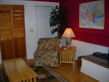 Another view of the living room.  Blinds and door opens to beautiful sunset views over the water.