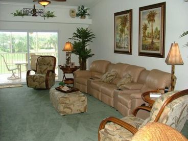 This beautiful Living Room with attached Veranda features comfortable Home Theater reclining seating for 6 people.