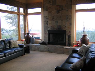 Large space open to upstairs with wood burning fireplace and full entertainment center. 