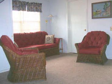 The comfortabe living room is open to the dining room, built in bunks, and day bed sleeping area.  
