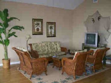 The open floor plan living room has coastal decor and overlooks Copano Bay.