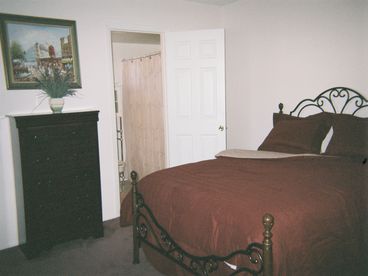 master bedroom queensize bed master bathroom  door walk in closet cable tv with cd and dvd player with movies
