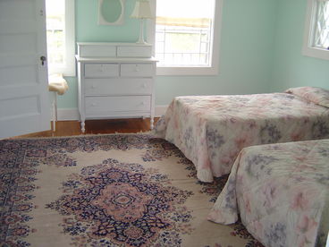 Large bedroom on first floor; two twin beds and in-room half bath.