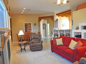 A view of the living room, dining room  & bar toward foyer.