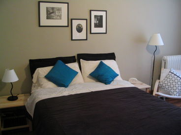 A typical bedroom with queen bed and private bathroom.