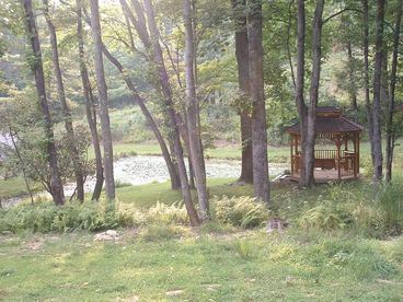 View from covered front porch overlooking pond & gazebo