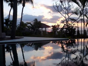 As the sun sets into the Bali Sea near East Java, the 18 meter pool reflect the colors