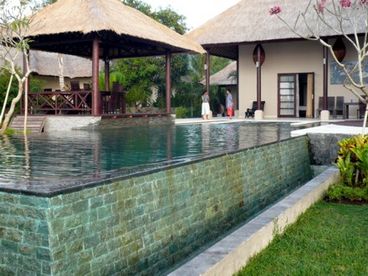 The private pool spills over  and cascades down the natural stones.  At the far end there is an integrated jacuzzi.