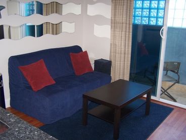 Beautiful brand new living room with a sliding glass door to balcony