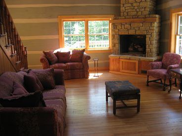 Beautiful spacious living room area with fireplace decorated for comfort and to serve at least 5 guests.